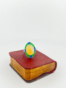 18k WG Opal cabochon ring with emerald and sapphire (5.18 ct) halo and diamonds